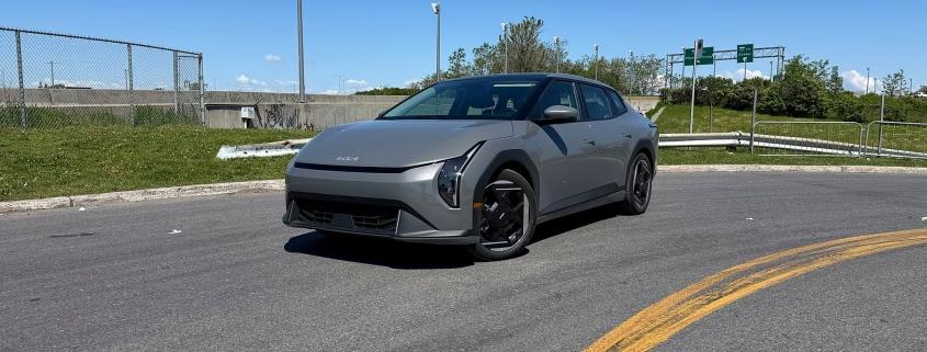 Kia EV4 Wind Premium 2026 gris Schiste vue de trois quarts avant, près d’une bretelle de l’autoroute 40